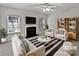 Virtually staged living room featuring a fireplace and comfortable seating at 2507 Oakdale Creek Ln, Charlotte, NC 28216
