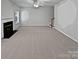 Large living room with fireplace and neutral carpeting at 2507 Oakdale Creek Ln, Charlotte, NC 28216