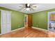 This bedroom features hardwood floors, a ceiling fan, and a closet for ample storage at 280 Linda St, Salisbury, NC 28146