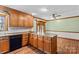 Kitchen island with wood cabinets and black appliances at 280 Linda St, Salisbury, NC 28146