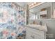 Bathroom with a bright floral shower curtain, vanity, and a large mirror at 30 Hunter St, York, SC 29745