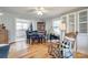 Well-lit dining room with hardwood floors, built-in cabinetry, and view to kitchen at 30 Hunter St, York, SC 29745