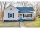 Charming home with a welcoming front porch, blue shutters and vibrant landscaping at 30 Hunter St, York, SC 29745