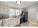 Cozy kitchen featuring white cabinets, a double sink beneath a window, and black appliances at 30 Hunter St, York, SC 29745