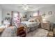 Charming bedroom with a textured ceiling, neutral walls, hardwood floors, and a cozy rug at 30 Hunter St, York, SC 29745