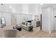 Open concept living space with a gray sofa and a view into the kitchen at 3020 Bellaire Dr, Charlotte, NC 28216