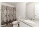 Bathroom featuring a granite countertop sink, decorative shower curtain, and updated fixtures at 310 Black Rock School Rd, Cherryville, NC 28021