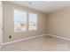 Cozy bedroom featuring carpet, two windows with blinds, and outlets for convenience at 310 Black Rock School Rd, Cherryville, NC 28021