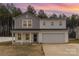 Charming two-story home with a covered porch and attached two car garage at 310 Black Rock School Rd, Cherryville, NC 28021
