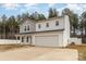 Charming two-story home with a covered porch, attached two car garage, and fenced-in yard at 310 Black Rock School Rd, Cherryville, NC 28021