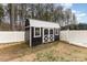 Backyard view of a storage shed featuring double doors, windows, and a metal roof at 310 Black Rock School Rd, Cherryville, NC 28021