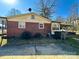 Home's backyard with a partial view of brick exterior, showing an outdoor area and a glimpse of the home's structure at 3520 Carlyle Dr, Charlotte, NC 28208