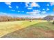 Large grassy backyard featuring a fire pit, picnic table, and some trees at 425 Webb Rd, Shelby, NC 28152
