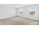 Spacious bedroom with plush carpeting and ample natural light streaming in from two large windows at 425 Webb Rd, Shelby, NC 28152