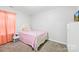 Cozy bedroom featuring a pink bed, matching curtains, and charming decor at 425 Webb Rd, Shelby, NC 28152