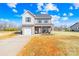 Inviting two-story home with vinyl siding, brick porch, attached garage and a well-maintained front yard at 425 Webb Rd, Shelby, NC 28152