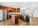 Well-lit kitchen featuring wood cabinets, stainless steel appliances, and a kitchen island with granite countertops at 425 Webb Rd, Shelby, NC 28152