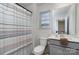 Well-lit bathroom with a shower, toilet, vanity with gray cabinets, and modern finishes at 452 Kennerly Center Dr, Mooresville, NC 28115