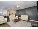 Inviting living room with tan leather sofas, a ceiling fan, and an open view to the kitchen at 452 Kennerly Center Dr, Mooresville, NC 28115