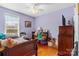 Bright bedroom with hardwood floors, featuring a comfortable bed and a window for natural light at 602 Woodland Dr, Kershaw, SC 29067