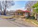 Charming brick home with a red carport offering sheltered parking and curb appeal at 636 Hillcrest Dr, Shelby, NC 28150