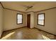 Bright bedroom with laminate floors, neutral walls, and two windows for natural light at 701 Eldorado St, Troy, NC 27371