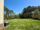Expansive backyard featuring a large grassy area, mature trees, and a fenced perimeter at 712 Kenway Loop, Mooresville, NC 28117