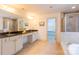 En-suite bathroom featuring double sink vanity, shower, and soaking tub at 712 Kenway Loop, Mooresville, NC 28117