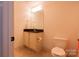 Powder room features tile floors, granite countertop, and a sink with white vanity at 712 Kenway Loop, Mooresville, NC 28117
