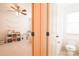 Half bathroom features a tile floor and is located off the playroom at 712 Kenway Loop, Mooresville, NC 28117