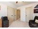 Bedroom featuring a desk and a closet is lit by a ceiling fan and a wall lamp at 712 Kenway Loop, Mooresville, NC 28117
