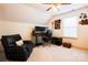A bedroom with a black desk and black leather chair is lit by a ceiling fan at 712 Kenway Loop, Mooresville, NC 28117