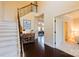 Spacious foyer featuring hardwood floors, a staircase and an adjacent dining area with elegant lighting at 712 Kenway Loop, Mooresville, NC 28117
