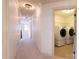 Hallway leading to the laundry room with modern washer and dryer units at 712 Kenway Loop, Mooresville, NC 28117