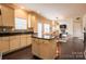 Open-concept kitchen with island, hardwood floors, and view of the living and dining areas at 712 Kenway Loop, Mooresville, NC 28117