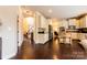 Spacious kitchen with white cabinets, stainless steel appliances, breakfast bar, and hardwood floors at 712 Kenway Loop, Mooresville, NC 28117