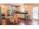 Modern kitchen with stainless steel appliances, granite countertops, and a central island with bar stools at 712 Kenway Loop, Mooresville, NC 28117