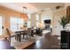 Open-concept living room with hardwood floors, a fireplace, dining area, and a two-story vaulted ceiling at 712 Kenway Loop, Mooresville, NC 28117