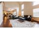 Spacious living room with high ceilings, hardwood floors, and an open layout to the kitchen at 712 Kenway Loop, Mooresville, NC 28117