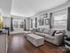 Inviting living room with a plush sectional sofa, hardwood floors, and abundant natural light at 7131 Thorncliff Dr, Charlotte, NC 28210