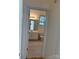 Bathroom view through doorway with a light vanity and toilet with a window at 765 N Alexander St, Charlotte, NC 28202