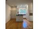 Open-concept living room with hardwood floors, recessed lighting, and access to the kitchen at 765 N Alexander St, Charlotte, NC 28202