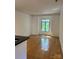 Spacious living room featuring hardwood floors and a large window at 765 N Alexander St, Charlotte, NC 28202