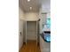 Hallway with a closet and a view into the kitchen featuring updated appliances and fixtures at 765 N Alexander St, Charlotte, NC 28202