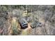 Aerial view of the property showcasing the house, detached garage, and surrounding wooded area at 7921 Fairmont Dr, Waxhaw, NC 28173