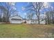 The backyard features an expansive green lawn and multiple white outbuildings at 7921 Fairmont Dr, Waxhaw, NC 28173