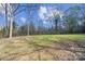Large open backyard with mature trees, offering a serene and private setting at 7921 Fairmont Dr, Waxhaw, NC 28173