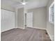 This bedroom offers hardwood floors, neutral walls, a window and a closet for storage at 7921 Fairmont Dr, Waxhaw, NC 28173