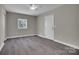 This bedroom features hardwood floors, neutral walls, a ceiling fan and a window for natural light at 7921 Fairmont Dr, Waxhaw, NC 28173