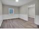 Neutral bedroom featuring hardwood floors, a modern window, and white trim at 7921 Fairmont Dr, Waxhaw, NC 28173